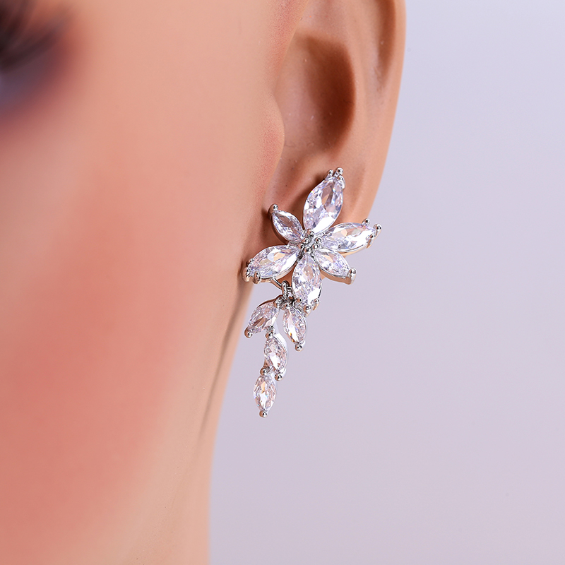 Decorative drop earring shown on an ear to illustrate visual scale