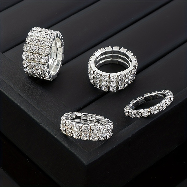 Clear-stone multi-row ring designs on a dark display