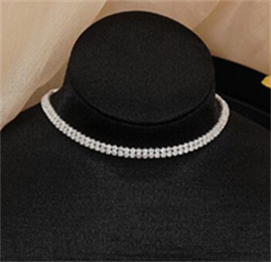 Narrow clear-stone choker on a black neck display