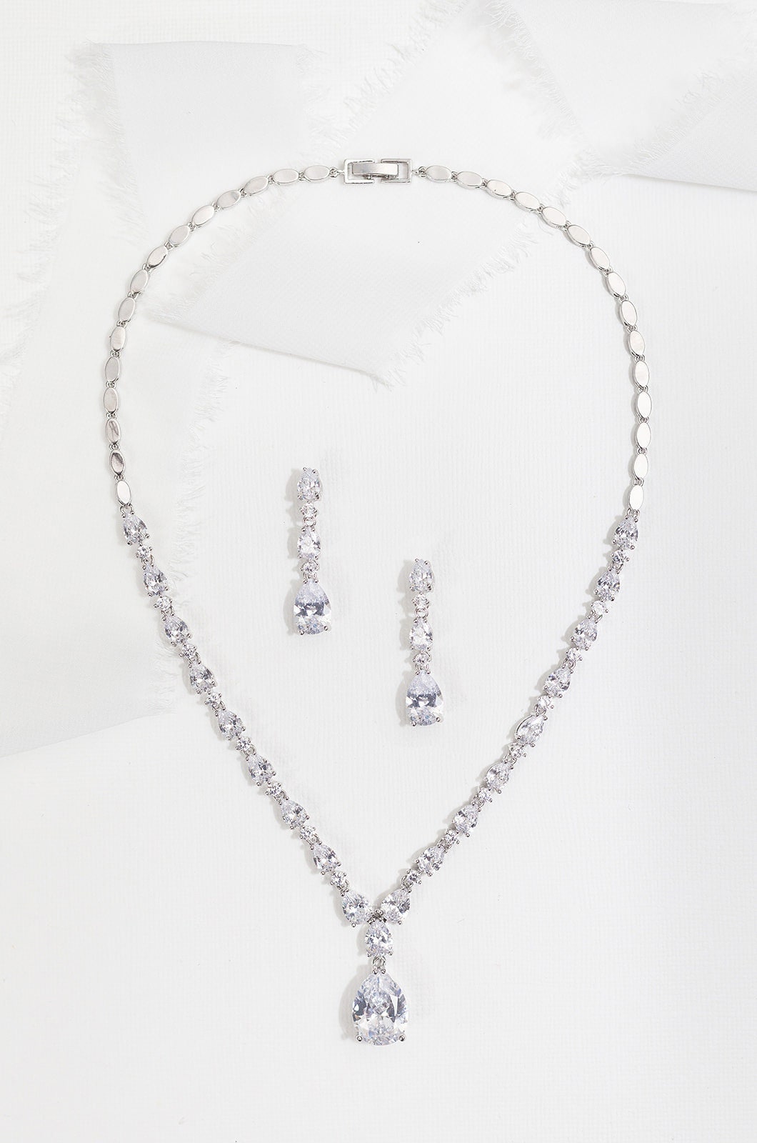 Coordinated necklace and drop earrings shown as a bridal styling reference